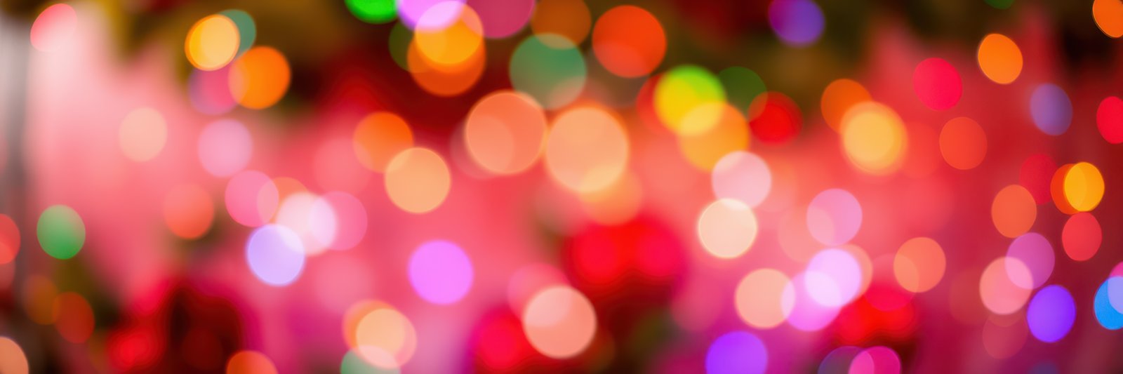 Colorful bokeh lights create a festive atmosphere during evening celebrations in a vibrant location
